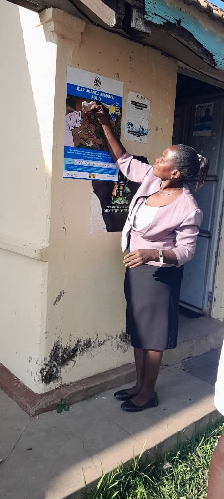 Edith Abeja, the District Health Educator displaying the polio campaign materials Edith Abeja, the District Health Educator displaying the polio campaign materials