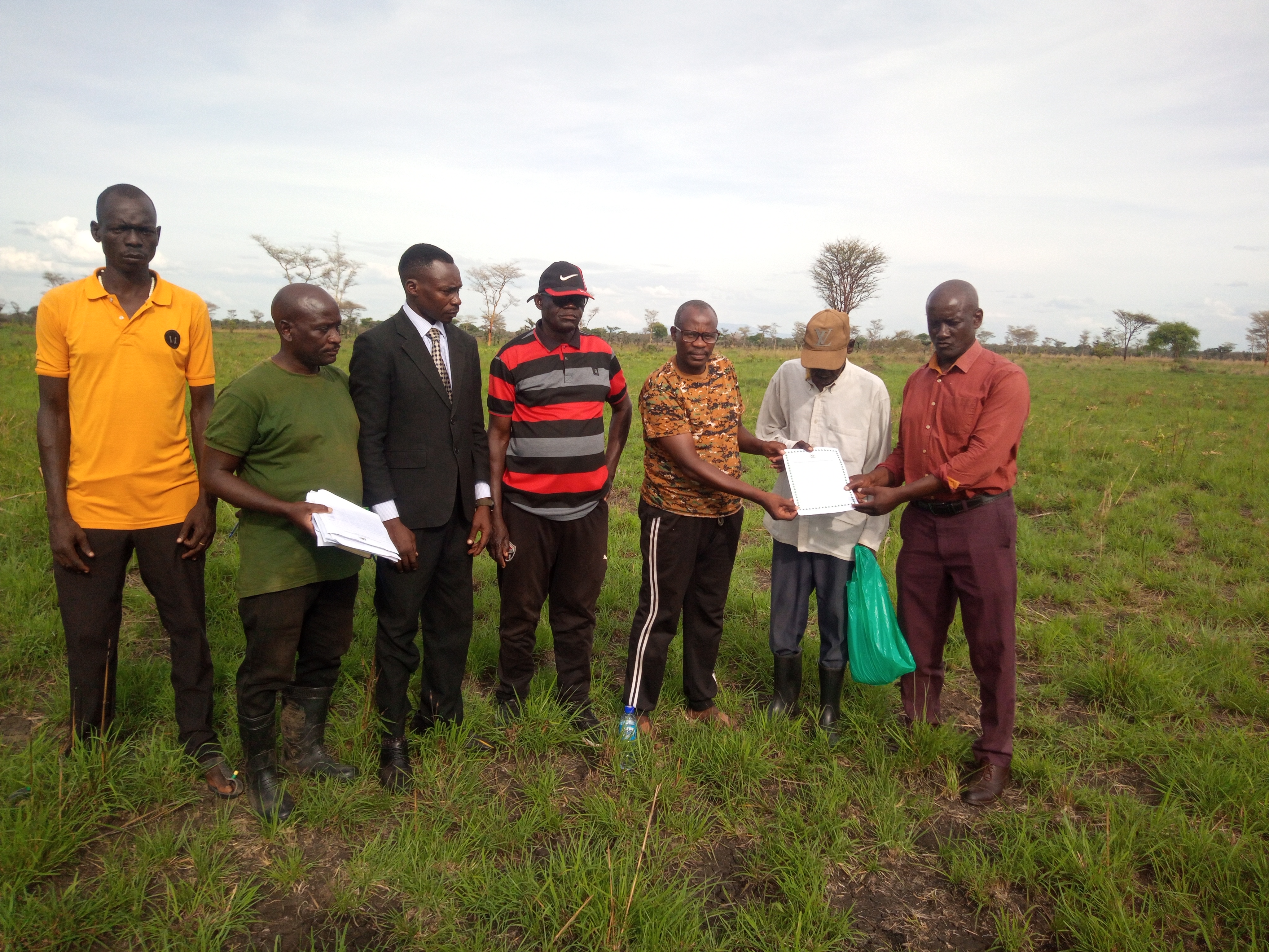 The Resident District Commissioner, Mr Olinga Tom Otukol with stakeholders of Aturai village displaying the site handover certificate on Thursday. The Resident District Commissioner, Mr Olinga Tom Otukol with stakeholders of Aturai village displaying the site handover certificate on Thursday.